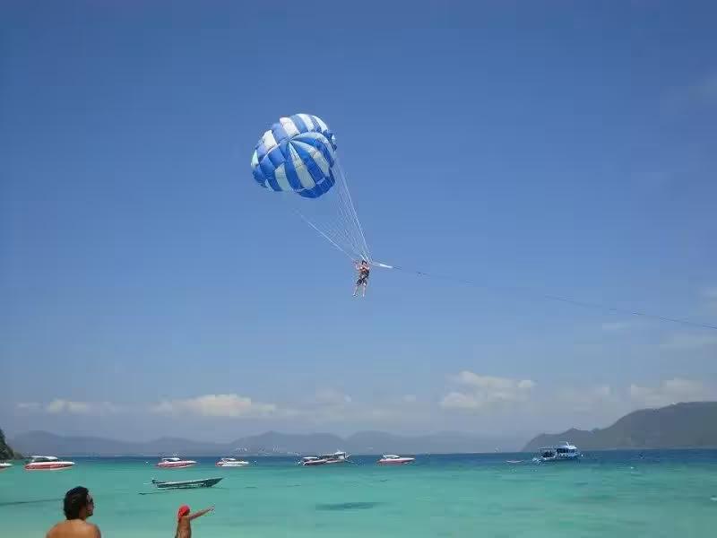 Thrilling parasailing activity over the blue sea at Coral Island