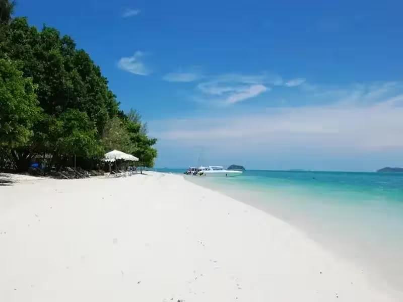 Relaxing on the beautiful beach at Rang Yai Island near Phuket.