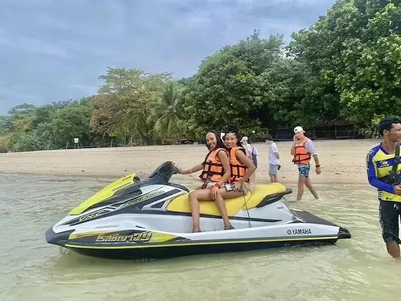 Couple riding a Yamaha jet ski on a tour around the islands of Phuket