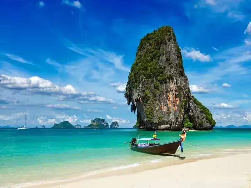Pristine white sand beach and towering limestone cliffs at Poda Island, Krabi