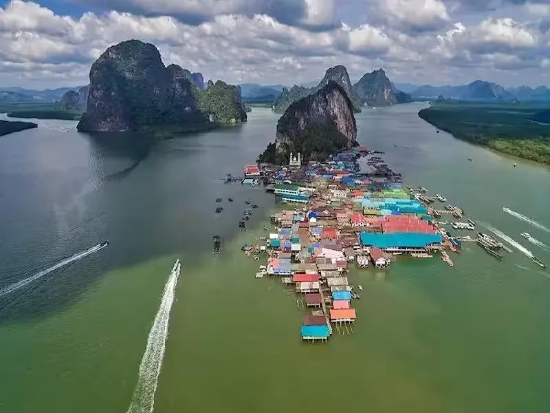 Traditional wooden houses and restaurants of the Koh Panyee floating village built on stilts in Phang Nga Bay