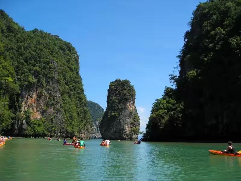 Tourists paddling a sea canoe into the hidden lagoon inside Hong Island, Phang Nga Bay