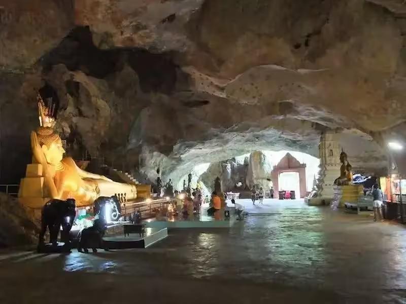 Large golden Buddha statue inside Suwankuha Temple (Monkey Cave)